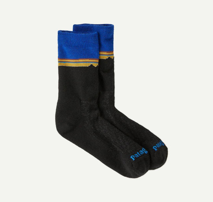 Black socks with blue and yellow striped cuffs on a white background