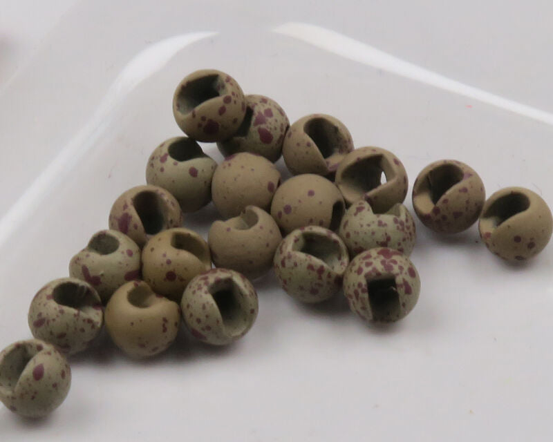 A pile of 1/8 inch Hareline Mottled Tactical Slotted Tungsten Beads in Hare's Ear Brown #178, displaying their heavy slotted design and earthy, matte brown mottled finish.