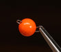 Size 1 Hareline Insta Jig 2.0 tungsten weights in Fl. Orange #137, showcasing the 0.6-gram keeled bodies coated in a high-visibility, smooth neon orange finish held on a vice.