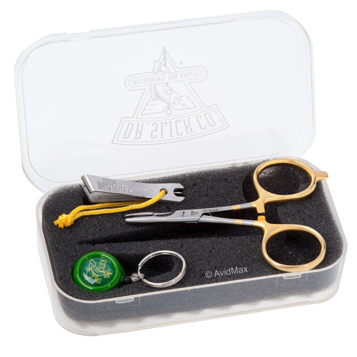 Dr. Slick Scissor Clamp Gift Set Six featuring a gold and black fly fishing scissor clamp, green pin-on-reel, and line nipper inside a clear plastic fly box