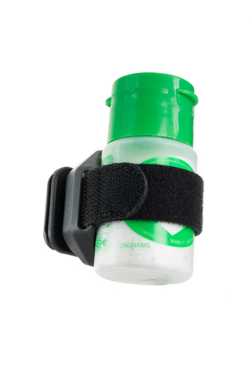 Umpqua Link DryDock Floatant Holder cradle securely gripping a green-capped fly fishing shake powder bottle.