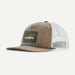 A Patagonia trucker cap featuring a brown corduroy front panel and brim, white mesh back panels, and a signature green Patagonia logo patch with a blue border on the front.