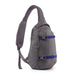A gray sling backpack with two blue compression straps and silver buckles, shown from a side profile view on a white background.