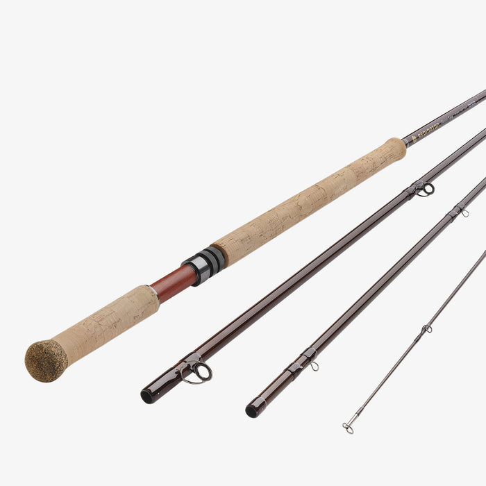 A fly-fishing rod shown in three separated sections on a light gray background, featuring a natural cork handle, a reddish-brown ferrule, and a dark brown graphite shaft.