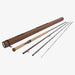 A fly-fishing rod set displayed on a light gray background, including a brown cylindrical case, a tan and red-handled rod section, and several dark metallic rod sections.