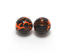 A pack of Hareline Crackle Slotted Tungsten Beads in Fl. Orange and Black #137, showcasing the heavy slotted beads covered in a high-contrast, vibrant neon orange and black mottled finish.