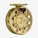 Gold fly fishing reel on a white background