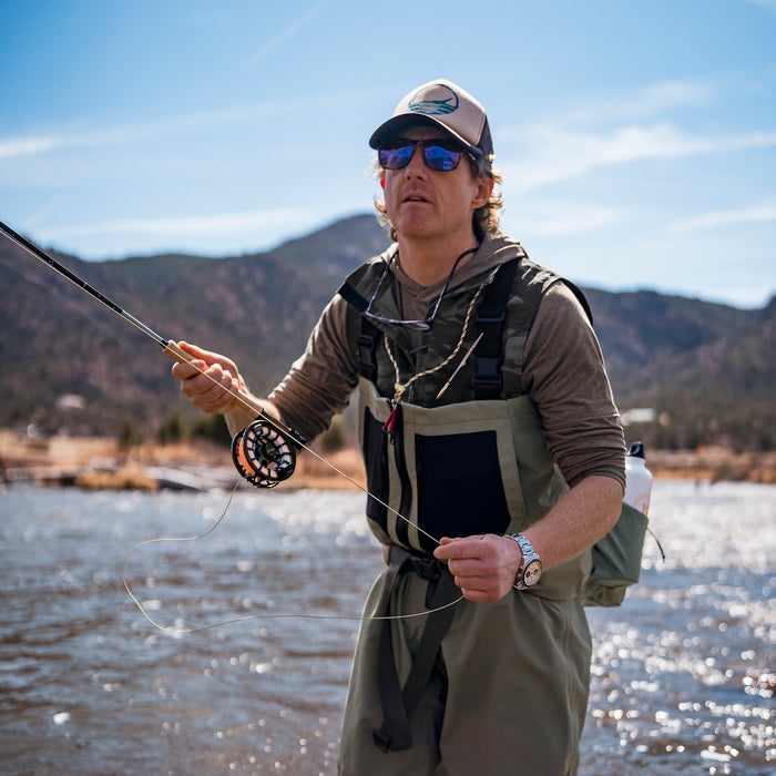 Angler wearing Orvis Clearwater Zip Waders fly fishing in river