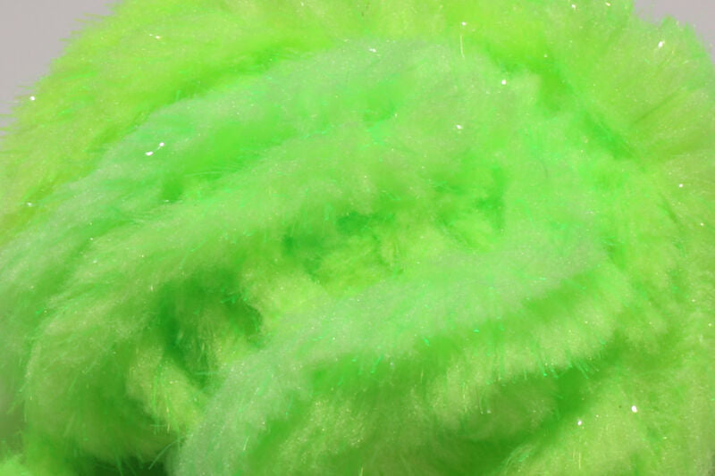 A close-up view of Hareline Easy Egg Chenille in Fl. Chartreuse #127, highlighting the fuzzy, high-visibility neon green-yellow fibers designed for turbid water fishing.