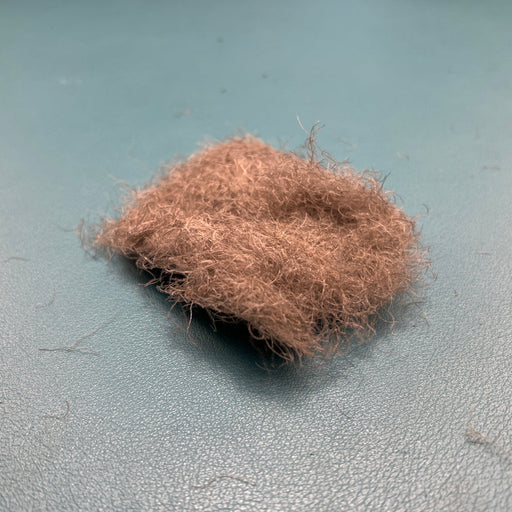 A close-up view of Fulling Mill CDC Dubbing in Natural Grey, showing the premium, fluffy Cul de Canard fibers ideal for realistic, high-floating dry fly bodies.