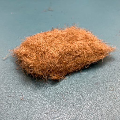 Fulling Mill CDC Dubbing in Tan color, showcasing the light, buggy texture of premium CDC feathers used for tying caddis and mayfly emerger patterns.