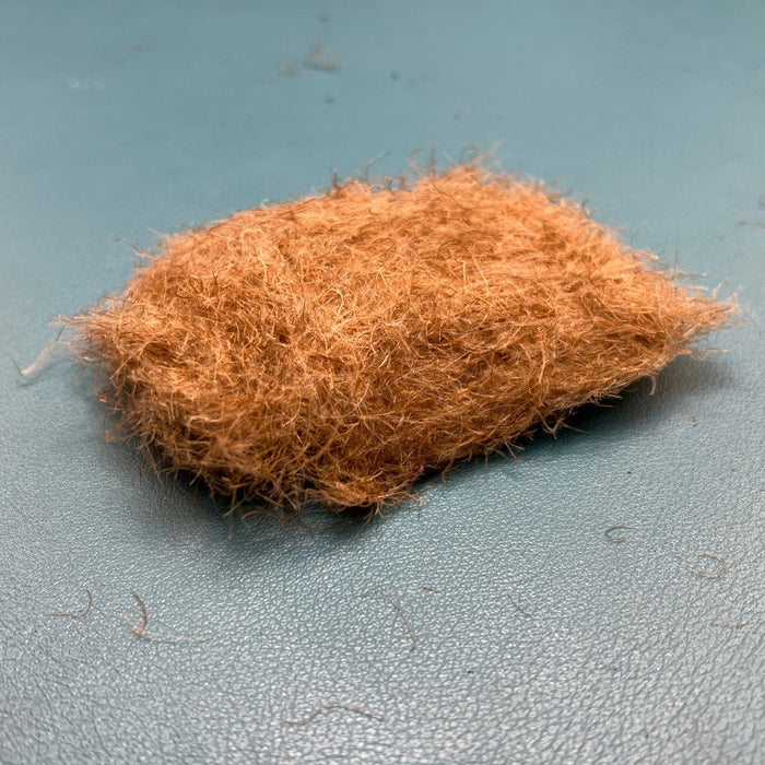 Fulling Mill CDC Dubbing in Tan color, showcasing the light, buggy texture of premium CDC feathers used for tying caddis and mayfly emerger patterns.