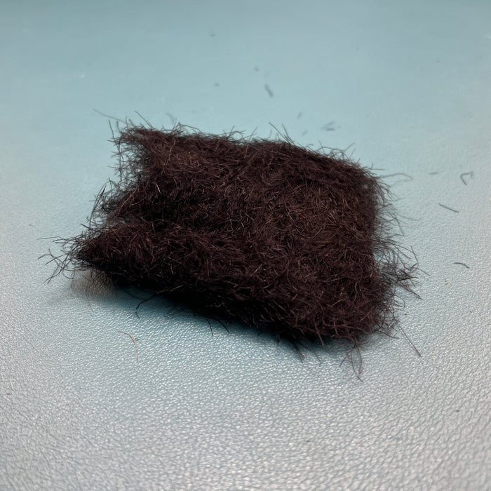 Fulling Mill CDC Dubbing in Black, displaying the dark, finely shredded Cul de Canard feather matrix suited for sub-surface nymphs, terrestrial bodies, and dark midges.