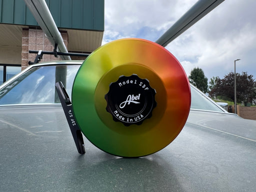 Abel SDF 5/6 freshwater fly fishing reel in custom solid rasta fade anodized finish with black handle