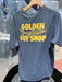 Smolder Blue Patagonia Capilene Cool Daily Shirt featuring the bold gold Golden Fly Shop text and fly graphic across the back.