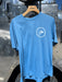 Shore Blue Patagonia Capilene Cool Daily Shirt showcasing the clean white circular trout fly logo on the left chest.