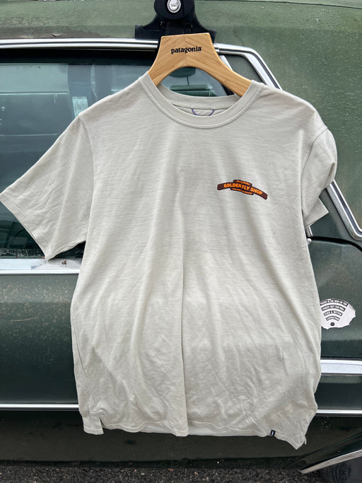Weathered Stone Patagonia Capilene Cool Daily Shirt hanging up, featuring the orange Golden Fly Shop logo on the left chest.