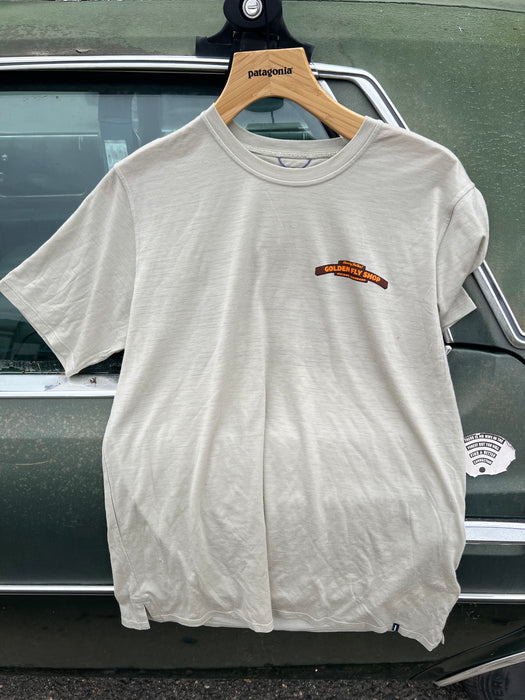 Weathered Stone Patagonia Capilene Cool Daily Shirt hanging up, featuring the orange Golden Fly Shop logo on the left chest.