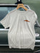 Weathered Stone Patagonia Capilene Cool Daily Shirt hanging up, featuring the orange Golden Fly Shop logo on the left chest.