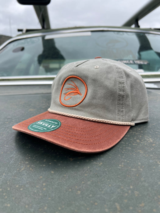 Golden Fly Shop Hat Skully Snapback Pebble Rust 2026 edition structured rope hat featuring a circular rust orange embroidered fly silhouette patch