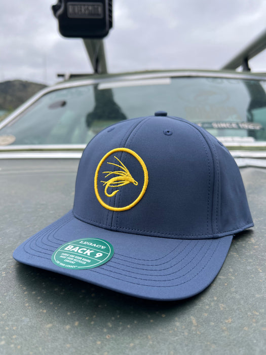Golden Fly Shop Back Nine Hat Sea Blue 2026 edition structured performance cap made from recycled materials featuring a circular gold embroidered fly silhouette patch