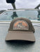 Dark Loden variant of the Golden Fly Shop Underwood Brown Trout Hat 2026 showing an olive green crown, tan accent rope, and large illustrated brown trout patch