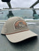 Solid Trenchcoat variant of the Golden Fly Shop Underwood Brown Trout Hat 2026 showcasing a tan khaki crown, matching mesh back, and large illustrated brown trout patch