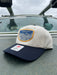 Golden Fly Shop Hat Underwood Cream Navy 2026 edition displaying a custom embroidered trout illustration patch on a Richardson structured mid profile frame