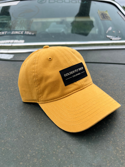 Golden Fly Shop 326 Hat Solid Mustard 2026 edition low-profile dad hat with a custom embroidered black Golden Fly Shop Colorado logo patch