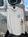Oyster off-white Grundens Tough Sun Hoodie hanging up, featuring the circular Golden Fly Shop Colorado logo patch.