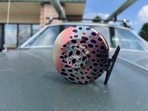 Close up view of the drag knob side on the Abel SDF 5/6 Native Trout fly reel highlighting the premium black handle and sealed drag casing