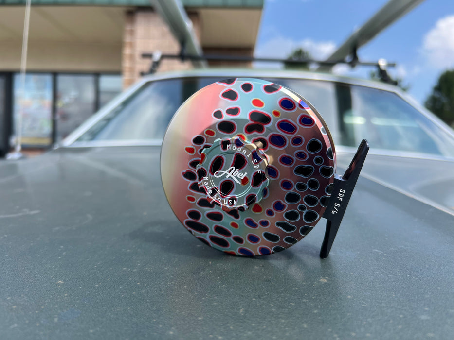 Close up view of the drag knob side on the Abel SDF 5/6 Native Trout fly reel highlighting the premium black handle and sealed drag casing