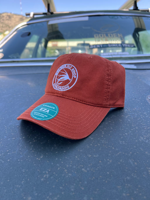Burnt Orange variant of the Golden Fly Shop Dad Hat 2026 displaying the earth-toned unstructured crown layout and circular embroidered fly logo patch