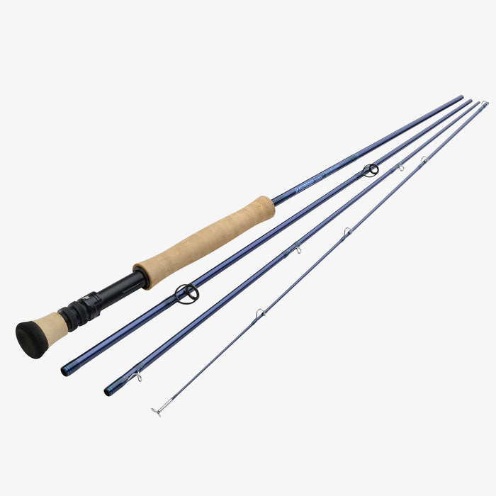 A four-piece fly fishing rod set shown disassembled, featuring a dark blue graphite shaft, a natural cork grip, and a black and cork handle on a light gray background.