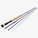 A four-piece fly fishing rod set shown disassembled, featuring a dark blue graphite shaft, a natural cork grip, and a black and cork handle on a light gray background.