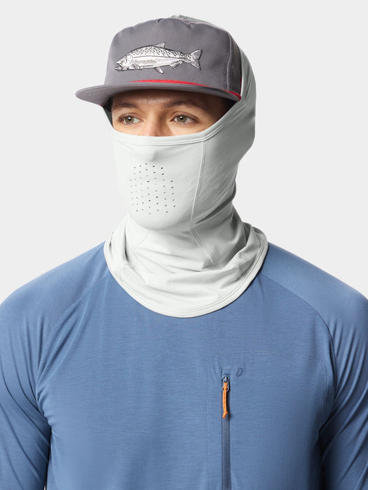 Angler wearing the Highrise grey Duck Camp Brrr Rockport Gaiter sun mask pulled up with a technical fishing hat.
