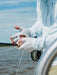 Angler wearing the Duck Camp Brrr Rockport Sun Glove while stripping a fly line on a flats boat.