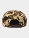 The back of a structured snapback cap featuring a complex camouflage pattern with scales, honeycomb, and organic shapes in beige, brown, green, and black, with a dark brown adjustable strap.