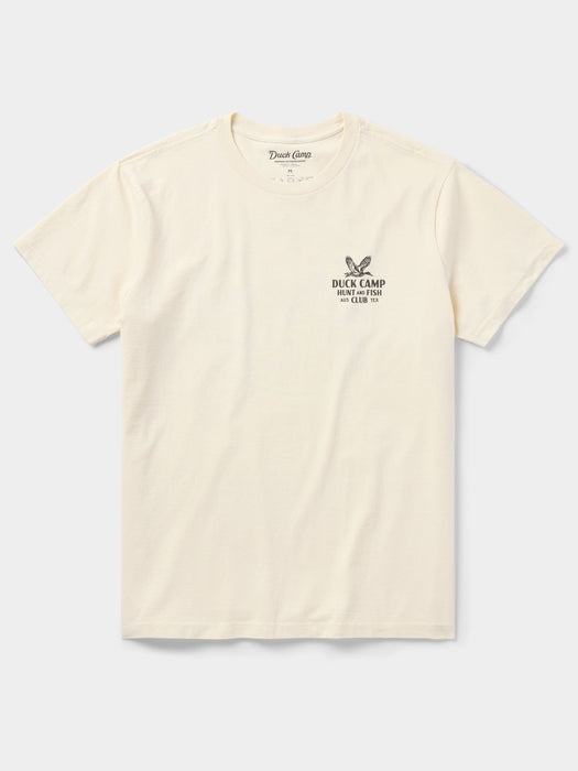 Front view of the Duck Camp Hunt and Fish Club Tee in Ivory, showing the small circular pocket logo on a premium cotton shirt.