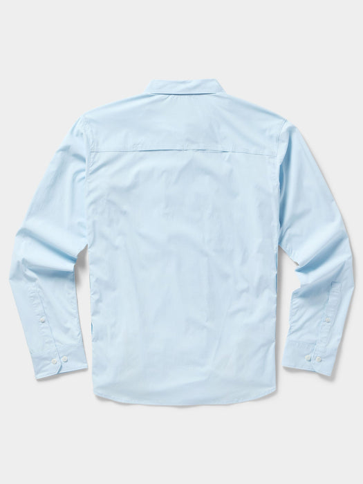 Back view of the light blue Duck Camp long sleeve fishing shirt showing the low-profile upper back cooling vents.