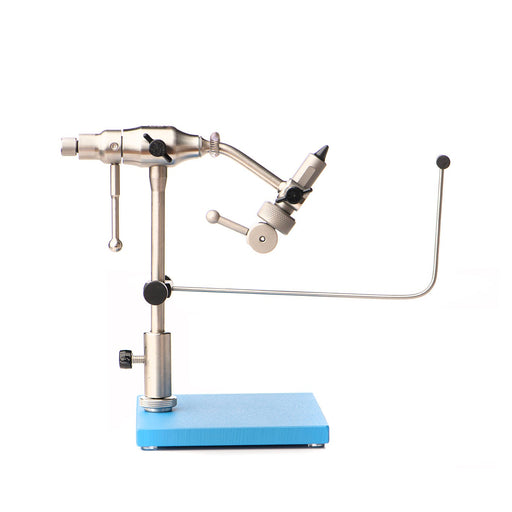 The Rambler Co. Atlas Fly Tying Vise mounted securely on its bright blue pedestal base, highlighting the stainless steel stem holder, integrated bobbin cradle, and precision jaws.