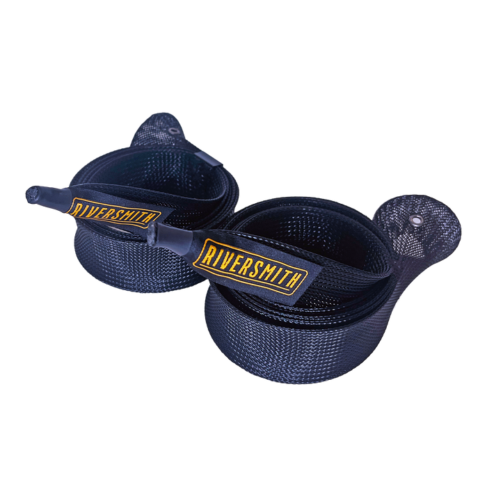 A pair of navy blue Riversmith Rig Wraps Fly Rod Sleeves coiled together showcasing the gold embroidered Riversmith logo and woven braid pattern