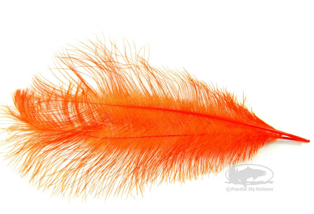 A premium Montana Fly Company Ostrich Plume dyed in a rich, bright Hot Orange, highlighting the dense layout of long, thin barbs ideal for tying steelhead intruder flies.