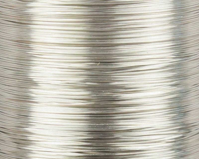 A close-up view of a spool of UNI-Soft Wire X-Small Silver #344, displaying the ultra-fine, highly reflective metallic silver wire wound tightly on the spool.