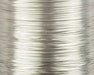A close-up view of a spool of UNI-Soft Wire X-Small Silver #344, displaying the ultra-fine, highly reflective metallic silver wire wound tightly on the spool.