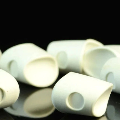 An assortment of Howitzer Baitfish Popper Heads in White #377, showing the clean, pre-shaped white closed-cell foam heads in small and medium sizes designed for custom fly-tying coloring.
