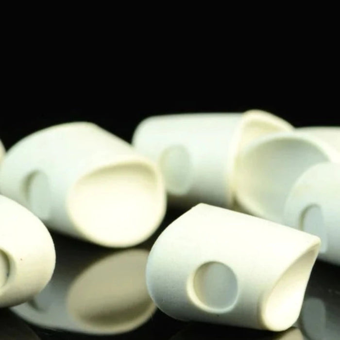An assortment of Howitzer Baitfish Popper Heads in White #377, showing the clean, pre-shaped white closed-cell foam heads in small and medium sizes designed for custom fly-tying coloring.