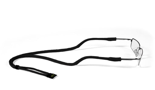 The Croakies Micro Suiter eyewear retainer in solid black attached to a pair of wire-frame glasses, highlighting the slim cotton-Lycra blend profile and the adjustable slider bead.