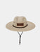 Front studio shot of the Duck Camp Crushable Flats Hat, showcasing its wide, protective woven palm straw brim, tan adjustable chin strap with toggle, and the genuine leather Duck Camp logo patch on the front crown.
