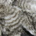A close-up of Hareline Grizzly Marabou feathers in Natural Grizzly #247, showcasing the classic, high-contrast black and white barred mottled pattern.